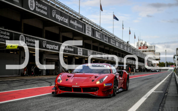 photo of a racing car at full speeds