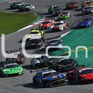 photo of several racing cars competing on a circuit